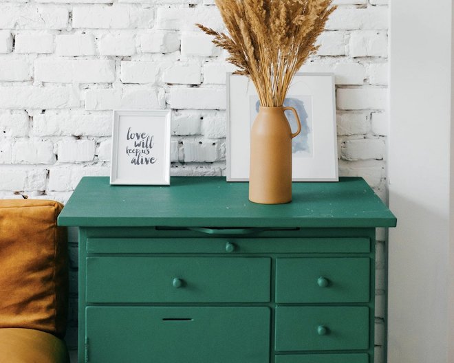 bedside table with vase and pictures